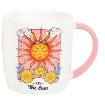Two mugs with celestial designs, one featuring a moon and the other a sun, on a white background.