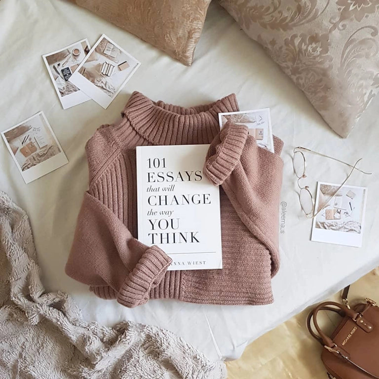 101 Essays That Will Change the Way You Think styled with a cosy jumper, photos, and soft textures — a mindful reading moment.
