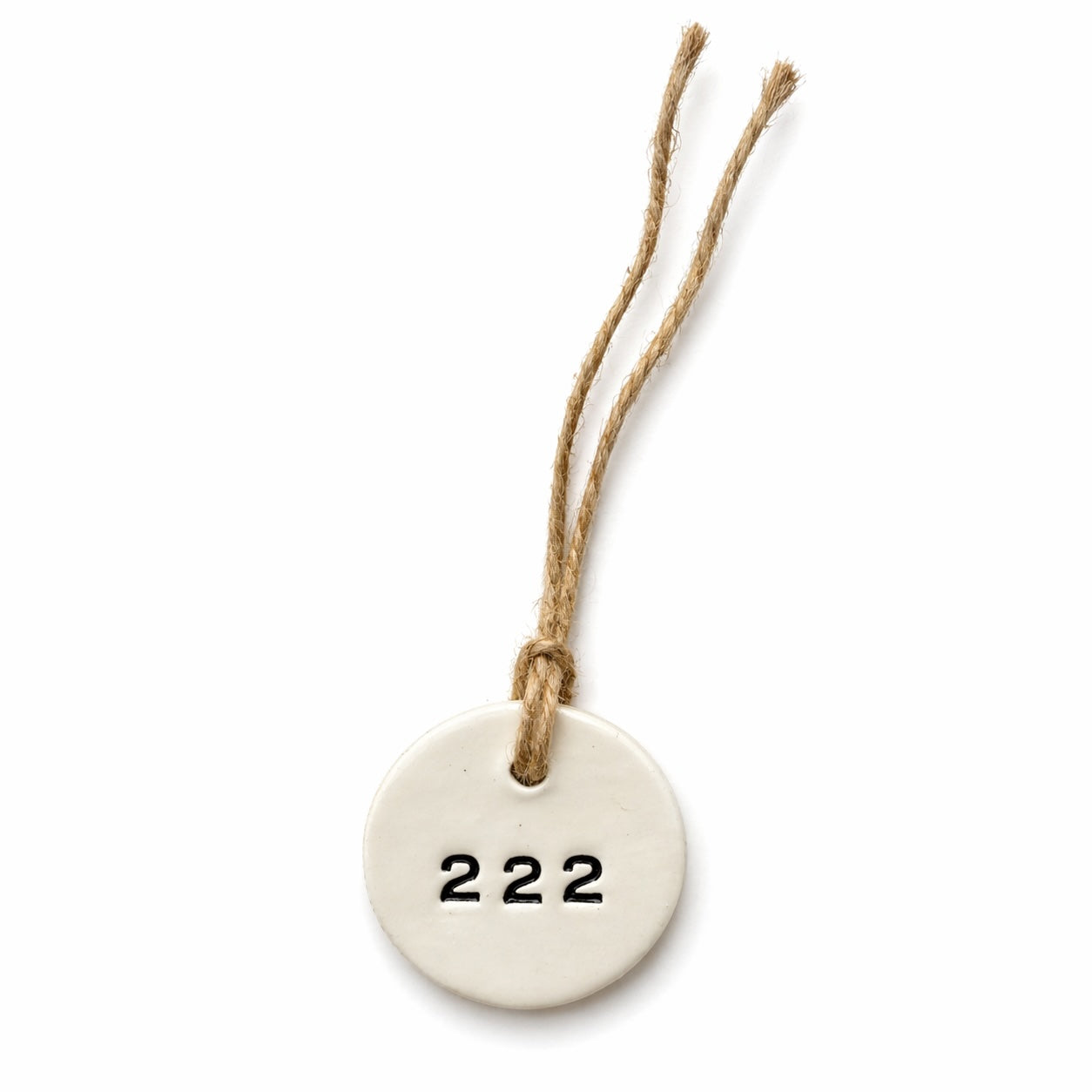 Handmade white round ceramic hanging tag with 222 angel number and natural jute twine