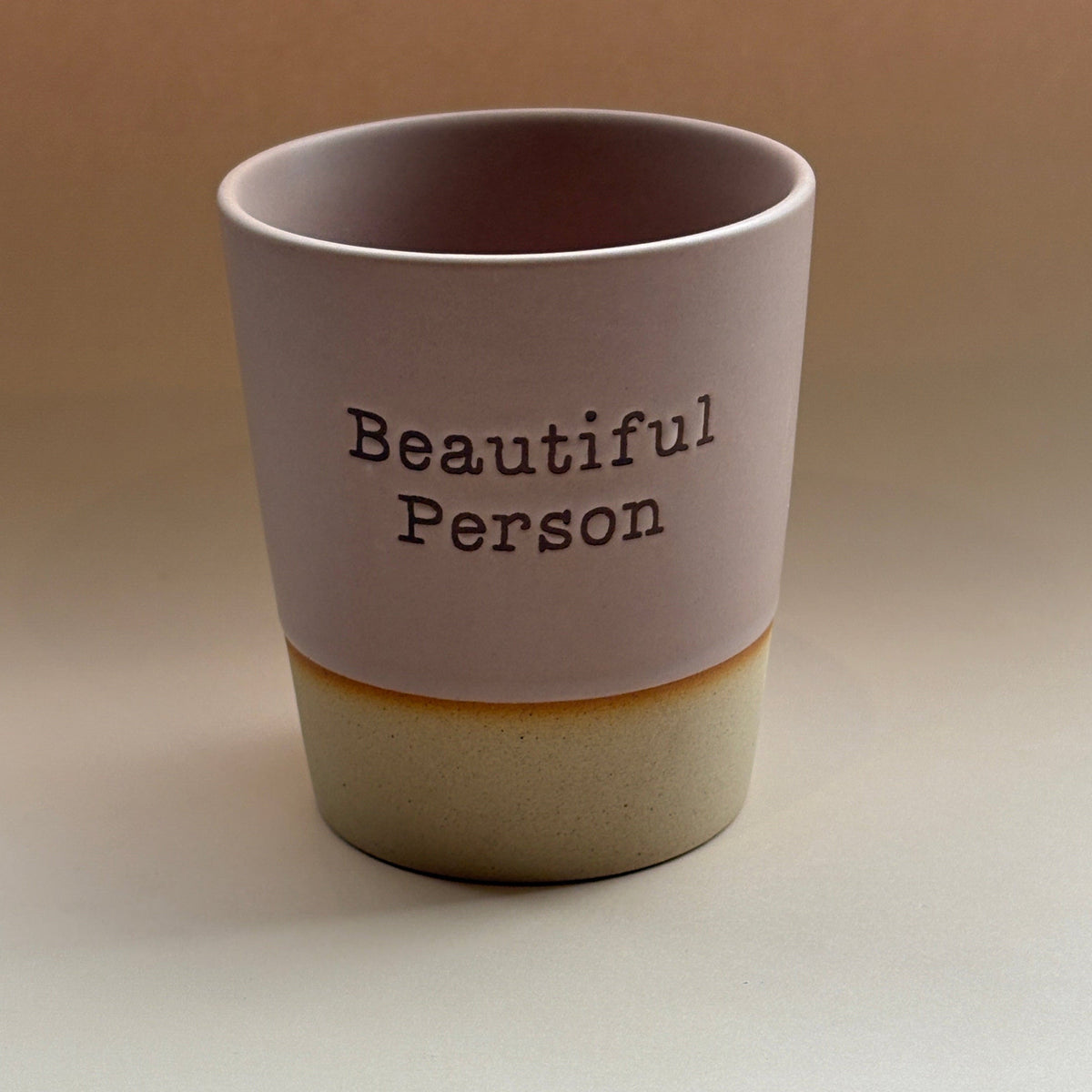 Tumbler with &#39;Beautiful Person&#39; text on a plain background