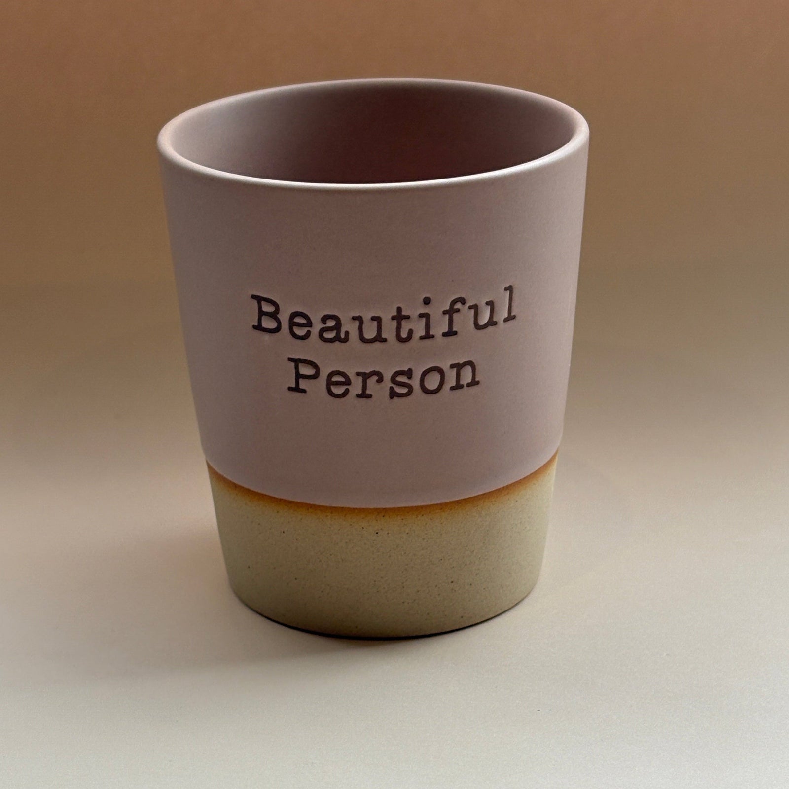 Tumbler with 'Beautiful Person' text on a plain background