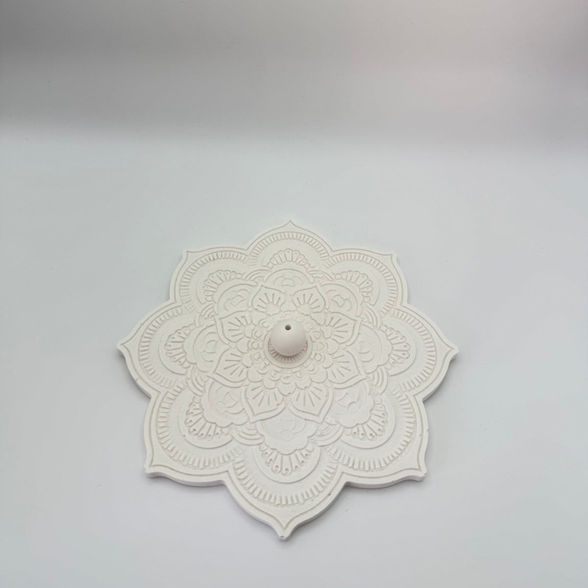 White mandala incense holder with detailed floral pattern 