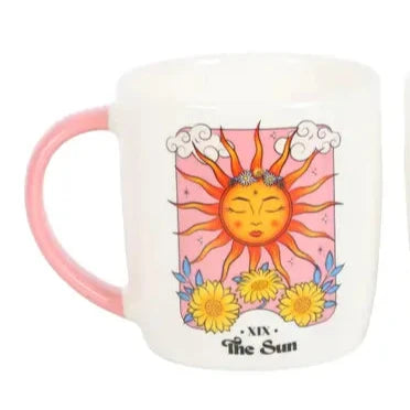 Two mugs with sun and moon designs on a white background