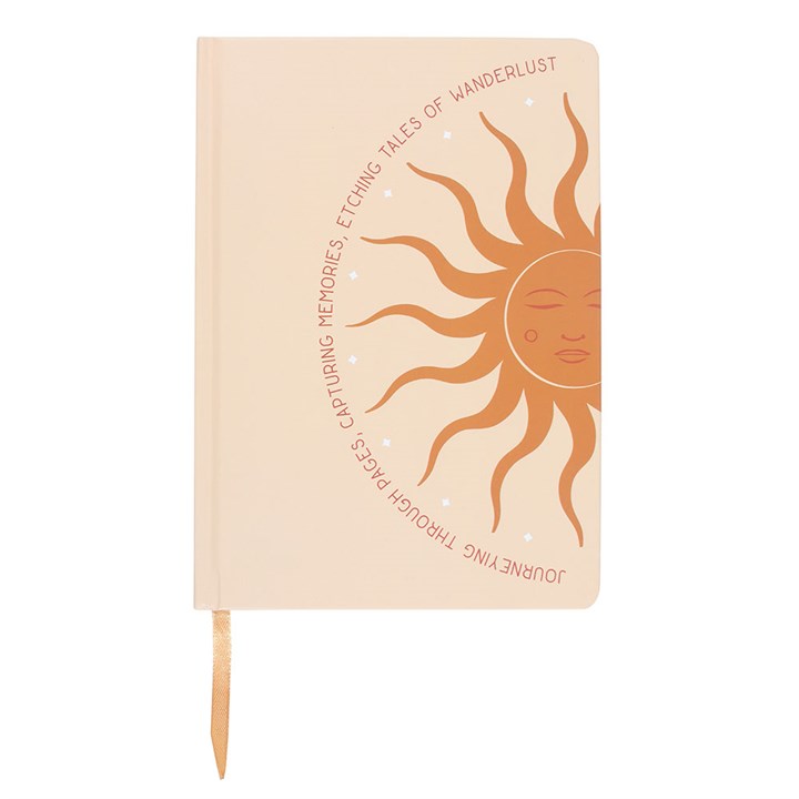 A5 lined notebook with sun design and the words “Journeying Through Pages, Capturing Memories, Etching Tales of Wanderlust” on the cover.