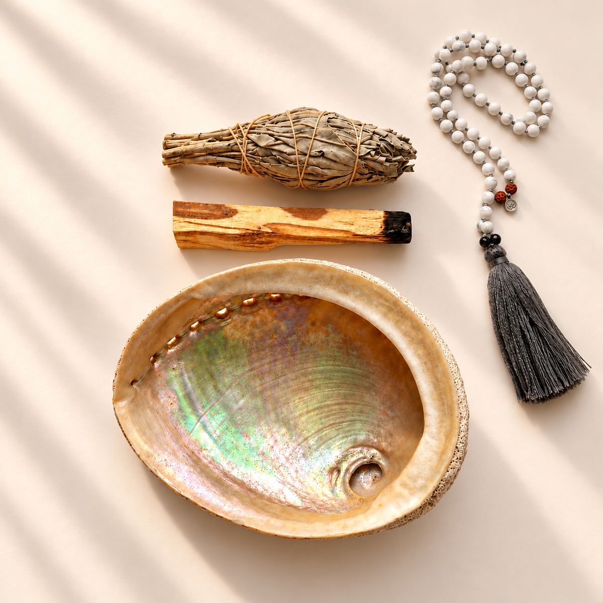 Abalone shell smudge kit with a white sage bundle, palo santo stick and a white beaded mala necklace with grey tassel by Luna &amp; Soul