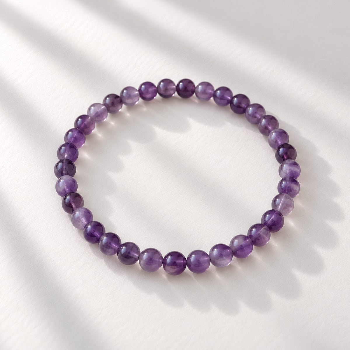 Amethyst beaded bracelet featuring petite 4 mm round purple beads.
