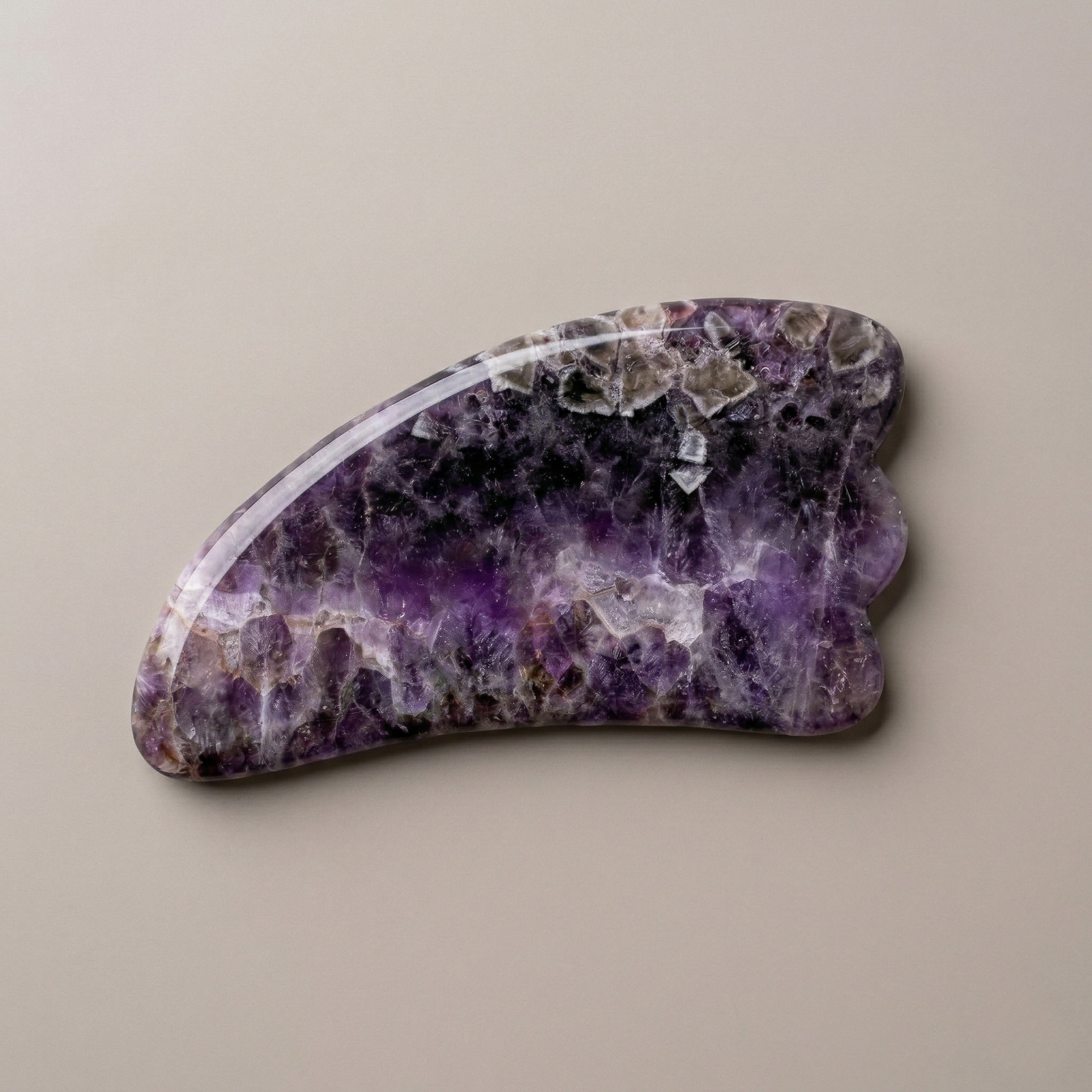 Natural amethyst gua sha facial massage tool for skincare and lymphatic drainage