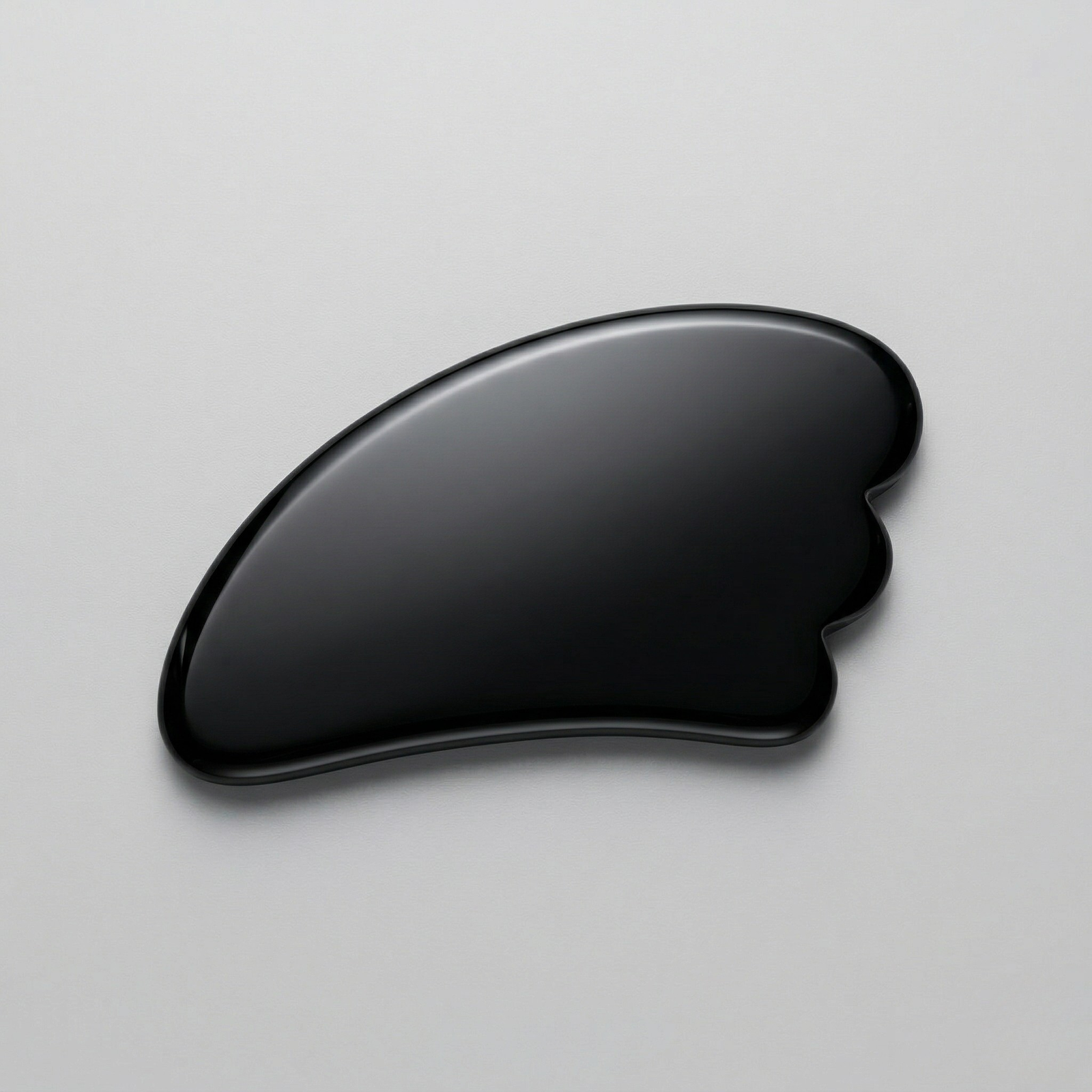 Natural black obsidian gua sha facial massage tool for skincare and lymphatic drainage
