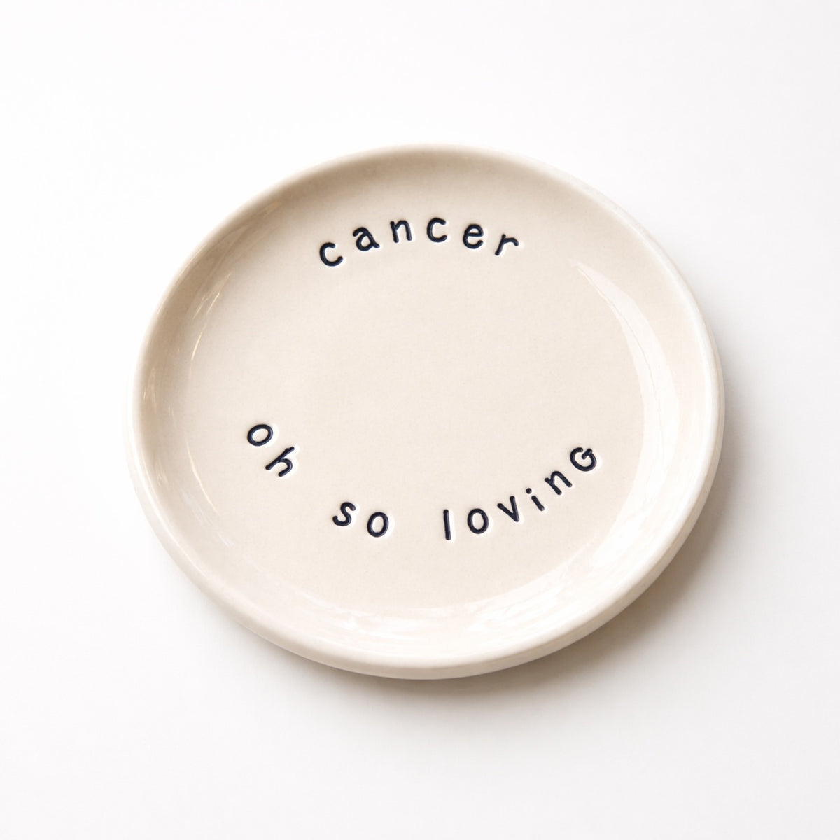Handmade Cancer zodiac ceramic plate with full of passion text in glazed earthenware

