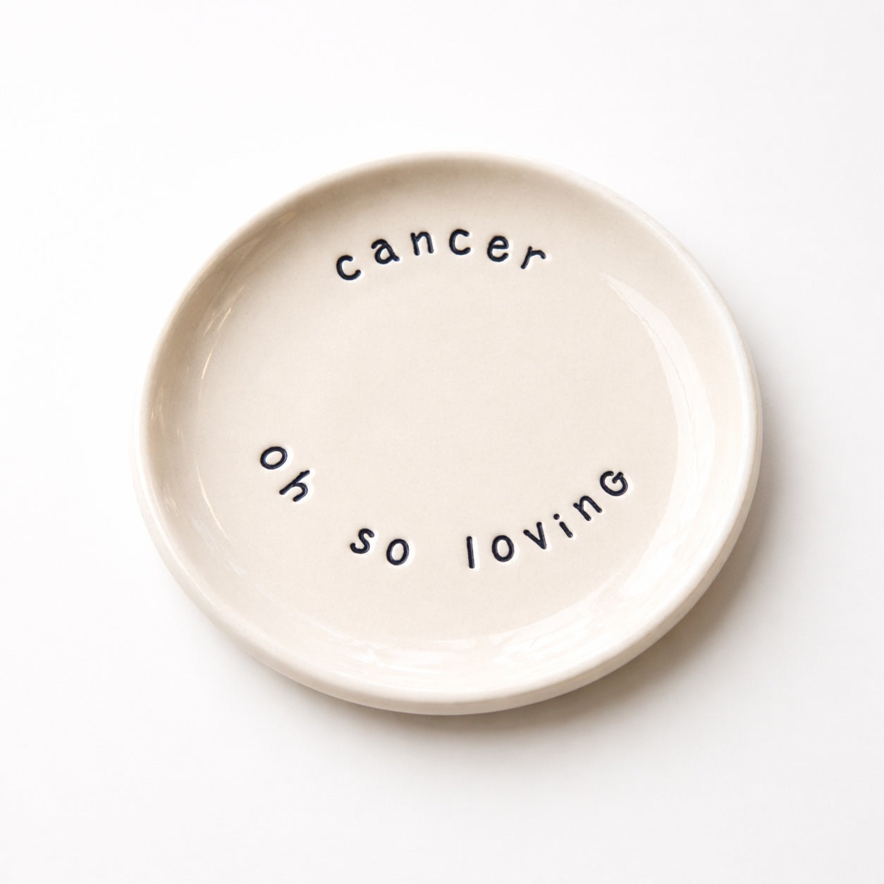 Handmade Cancer zodiac ceramic plate with full of passion text in glazed earthenware
