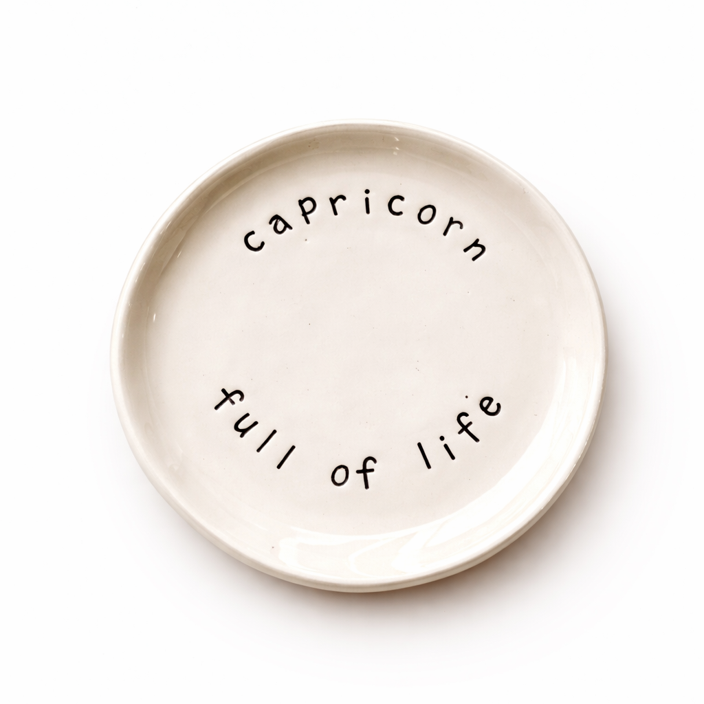 Handmade Capricorn zodiac ceramic plate with full of life text in glazed earthenware