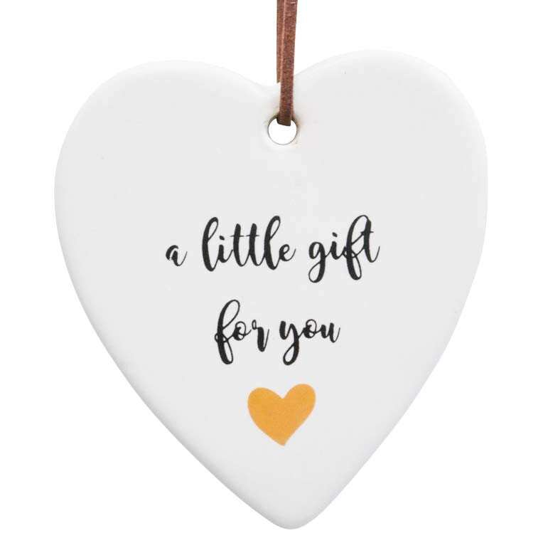 White ceramic hanging heart with inspirational quote and brown hanger