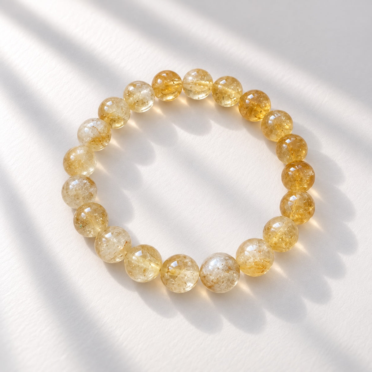 Citrine beaded bracelet featuring 10 mm round yellow to golden toned beads. 