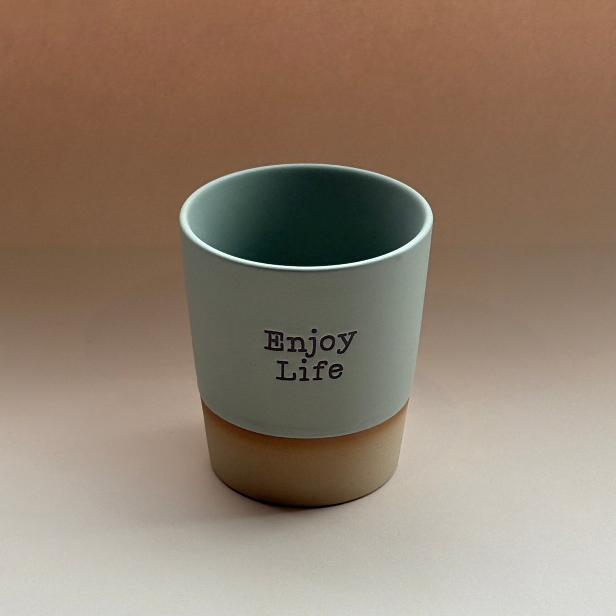 Ceramic mug with &#39;Enjoy Life&#39; text on a gradient background