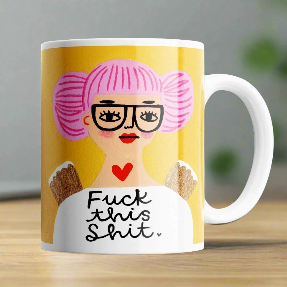 Humorous Fuck This Shit mug sitting on a desk – perfect cheeky ceramic coffee mug gift.