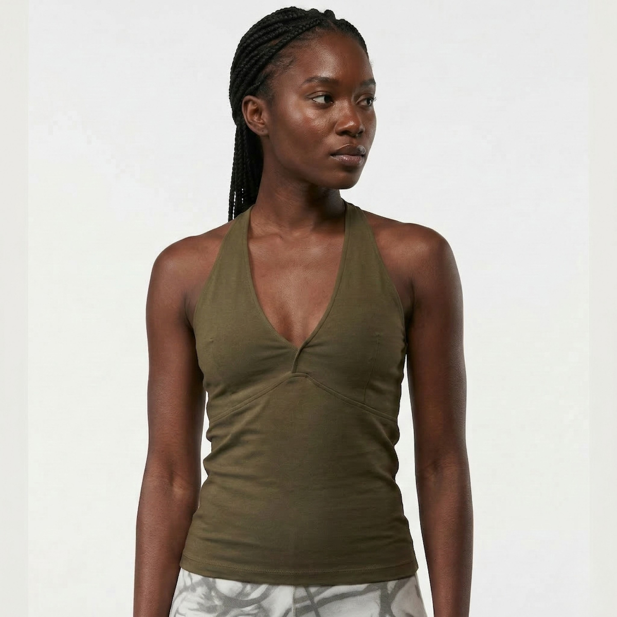 Black Woman wearing an organic cotton yoga tank with racerback design in olive