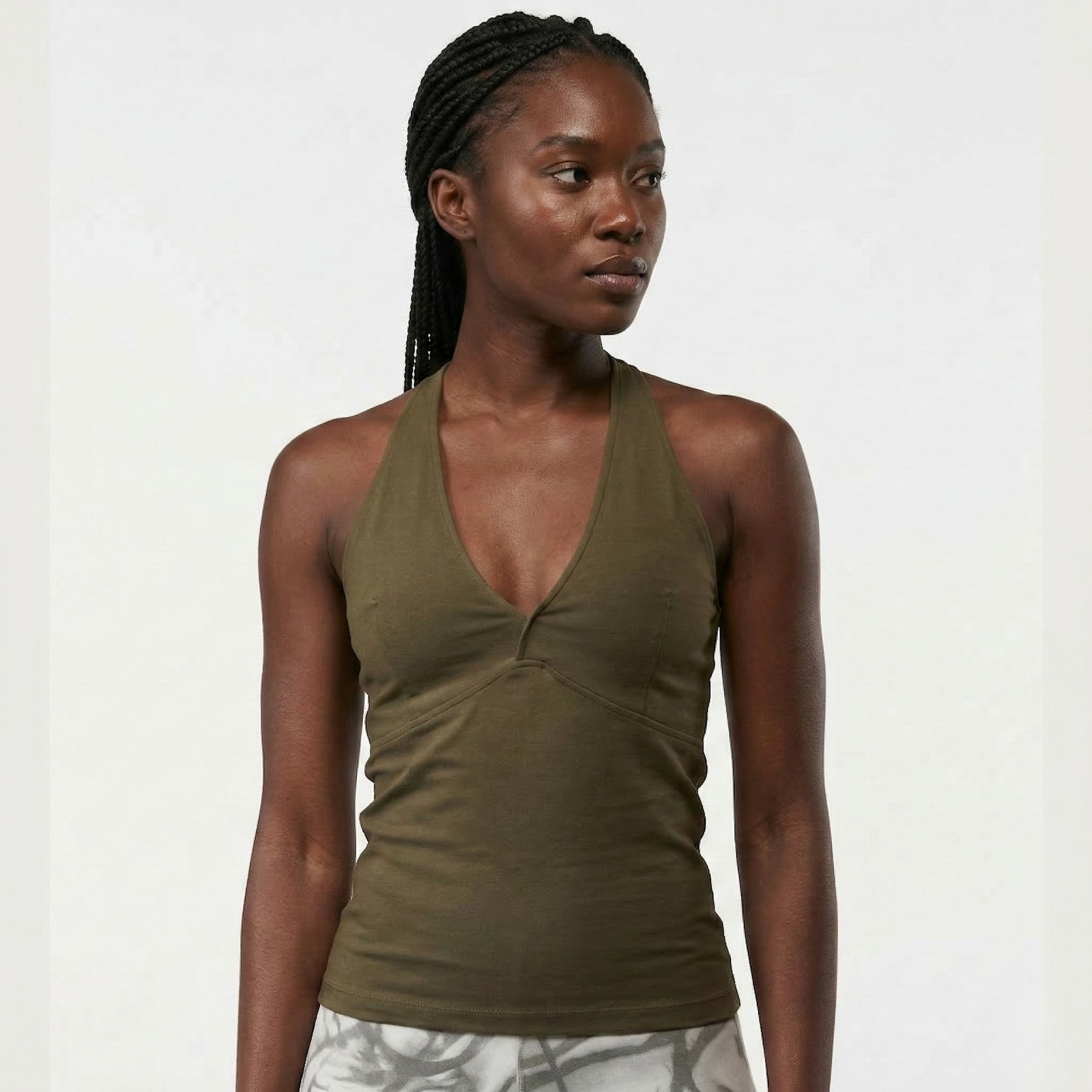 Black Woman wearing an organic cotton yoga tank with racerback design in olive