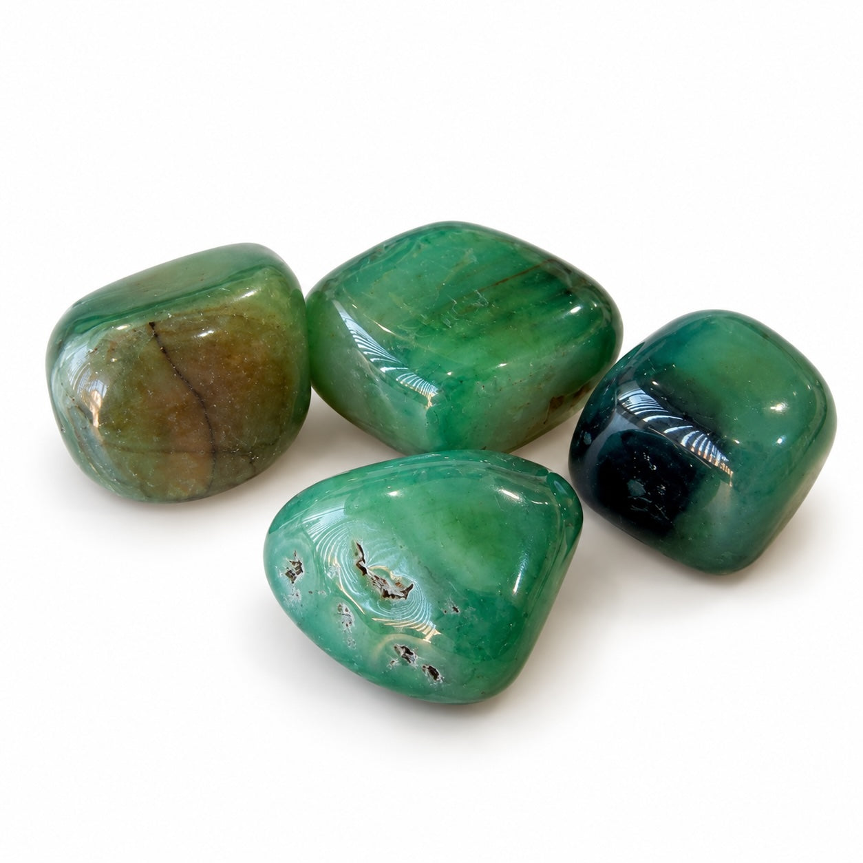 Polished Green Agate tumble stone from Brazil showing natural-looking green colour and agate patterns.