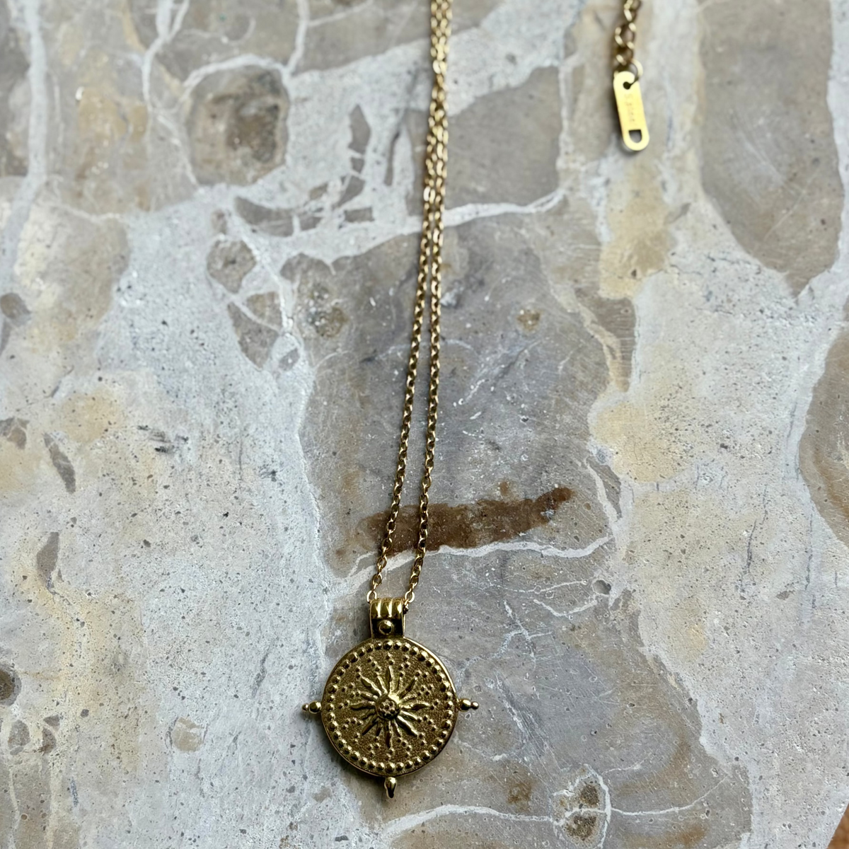 Mindful golden talisman necklace symbolising warmth, clarity and protect