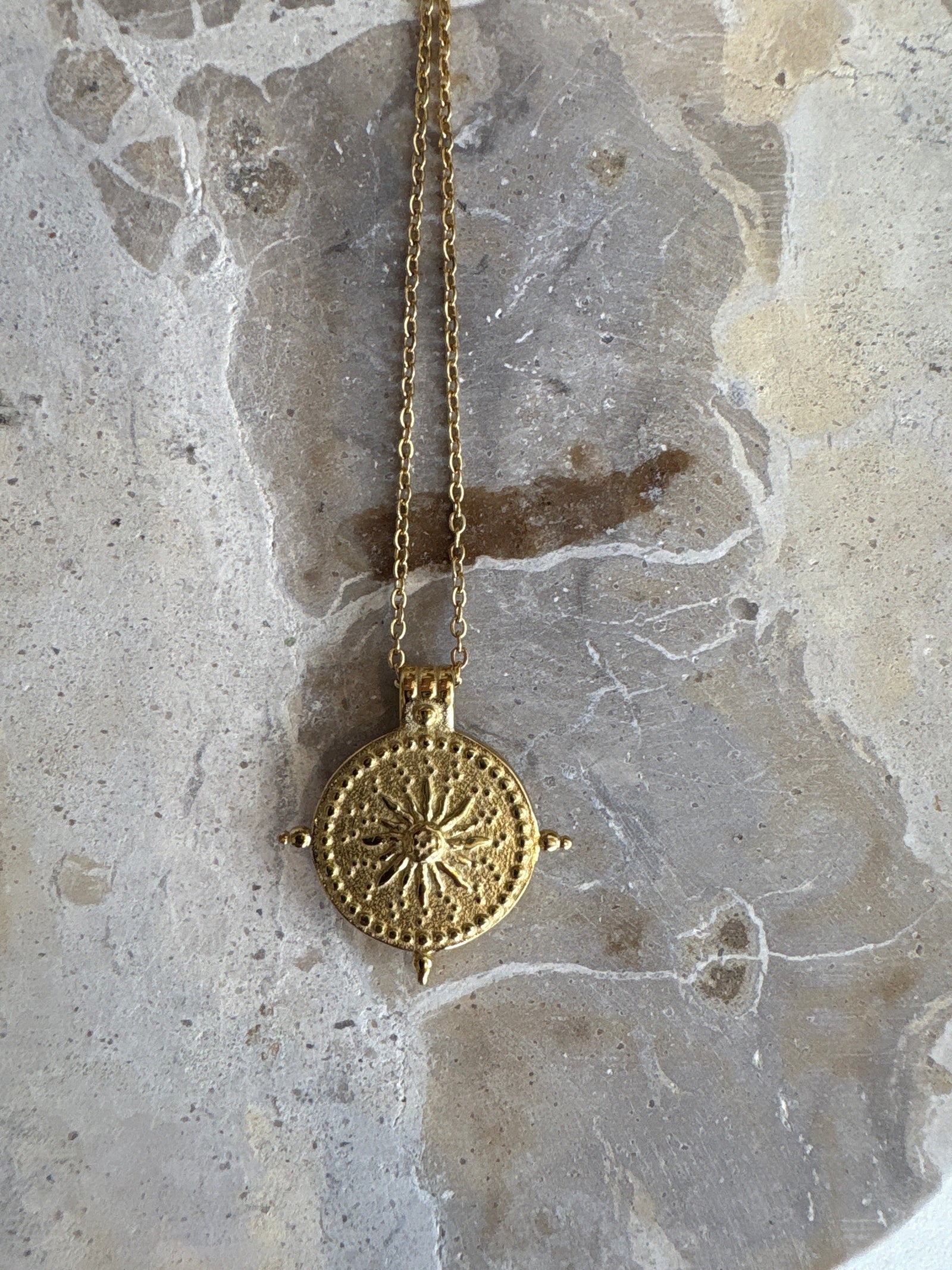 Guiding Sun Necklace in golden stainless steel with engraved sun motif