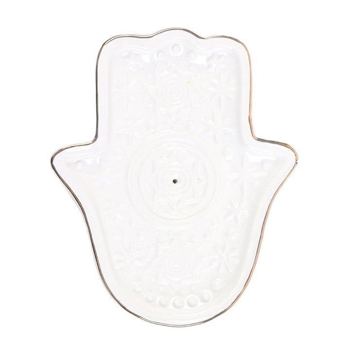Side angle of white ceramic Hamsa Hand incense holder showing embossed celestial design.
