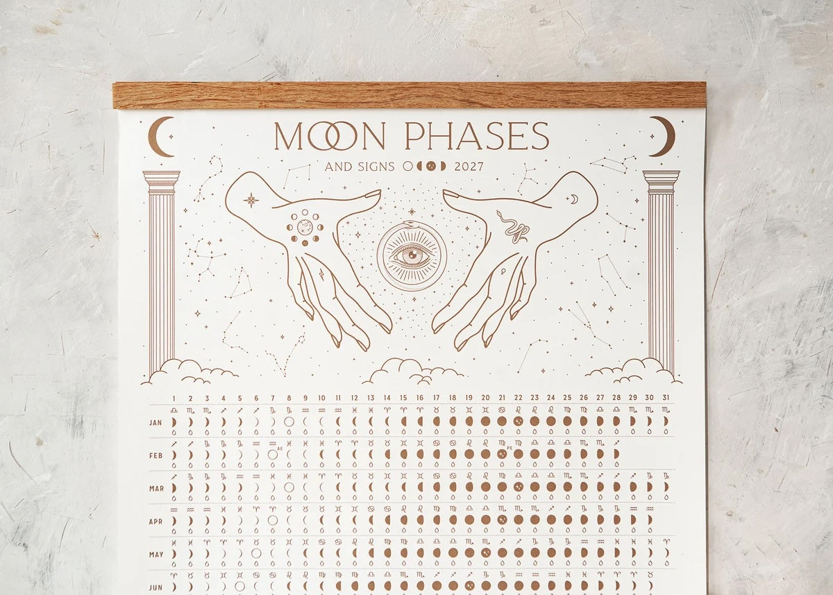Close-up detail of Magic of I 2027 Moon Phases calendar showing moon signs and phases.