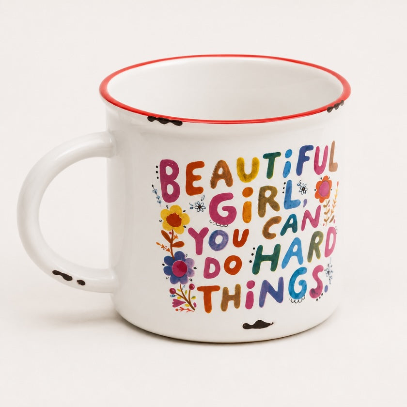 White enamel style mug with colourful floral details and “Beautiful girl you can do hard things” inspirational quote in multicoloured lettering.