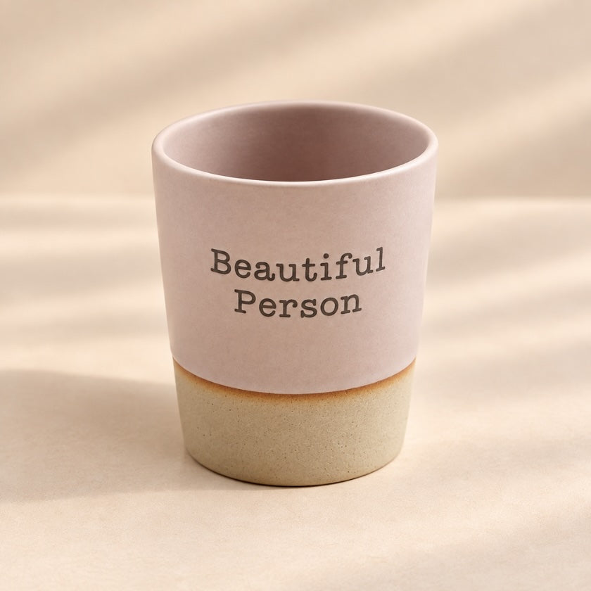 Beautiful Person hand-glazed ceramic mug in soft blush pink with natural-toned base.