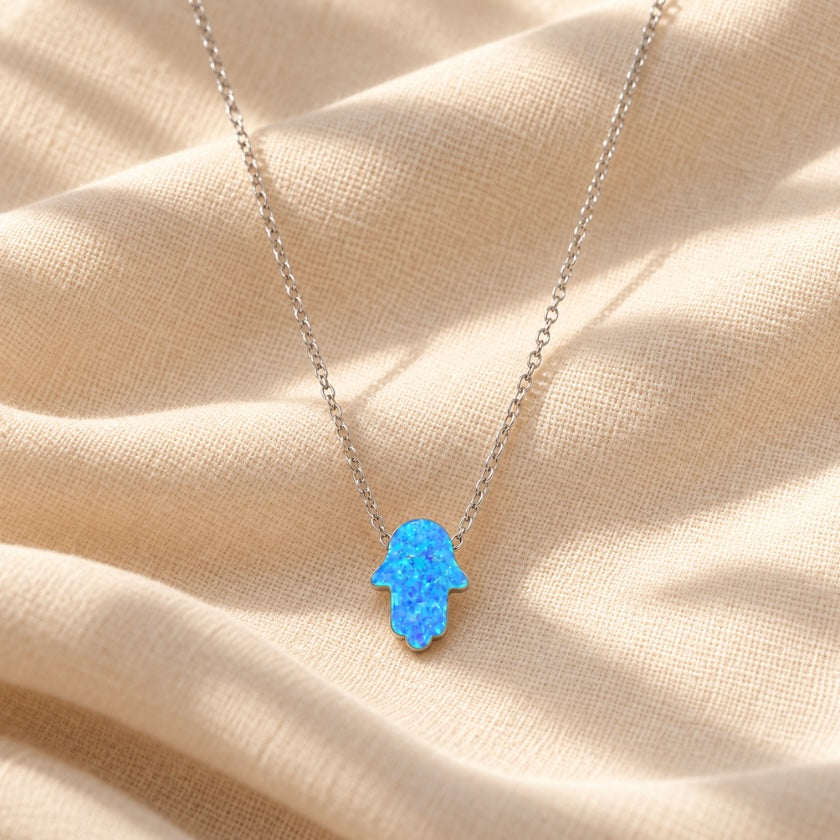 Blue opalite Hamsa hand pendant on a delicate sterling silver necklace.