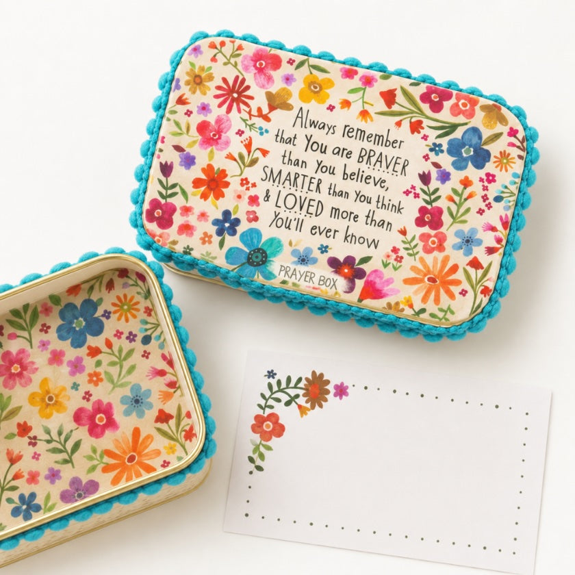 Floral prayer box set with colourful botanical design, turquoise pom pom trim and inspirational “Braver, smarter and loved more than you’ll ever know” quote, styled with matching note card.