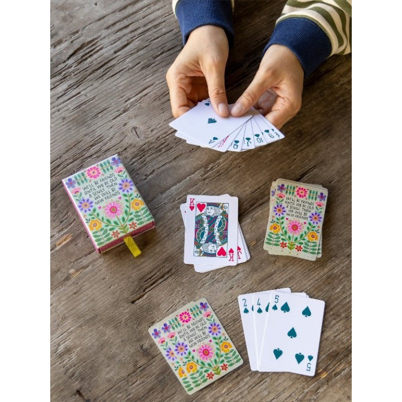Playing cards with floral design and friendship quote in illustrated gift box