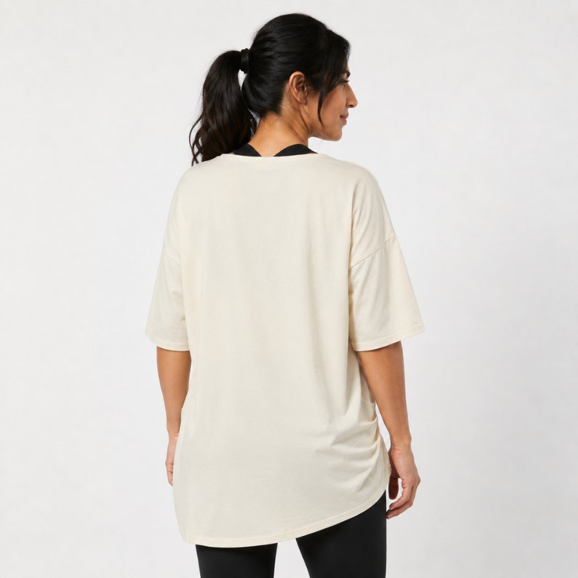 Back view of Luna &amp; Soul Zen organic cotton yoga top in oat — oversized fit with black leggings