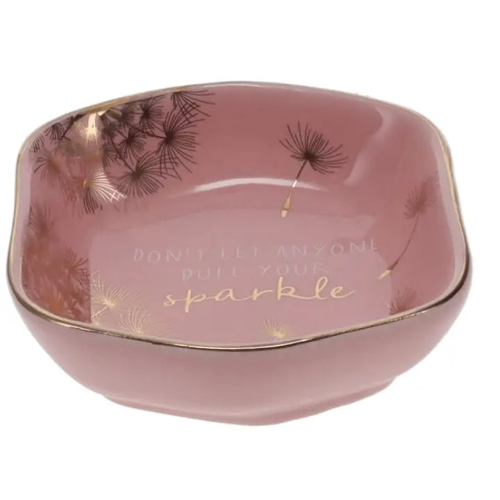 Front of Luna &amp; Soul blush pink ceramic trinket dish with dandelion illustrations and the quote "Don't Let Anyone Dull Your Sparkle".