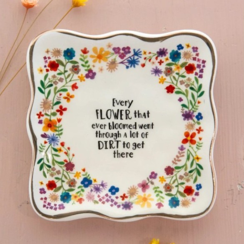 Ceramic trinket dish with floral design and gold rim featuring encouraging quote Every Flower That Ever Bloomed by Luna and Soul