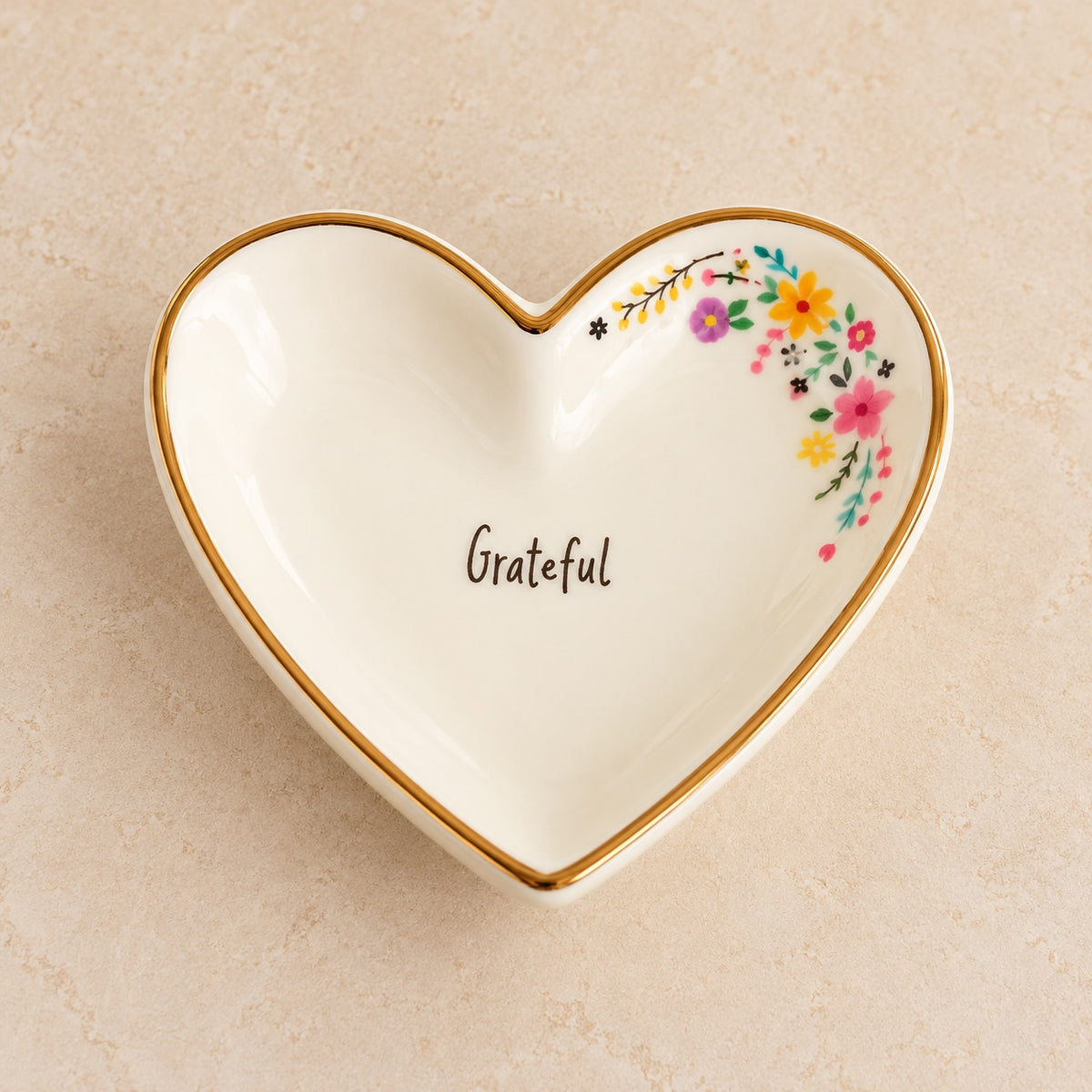 Medium cream ceramic heart trinket dish with gold-toned rim, colourful flowers and Grateful lettering.