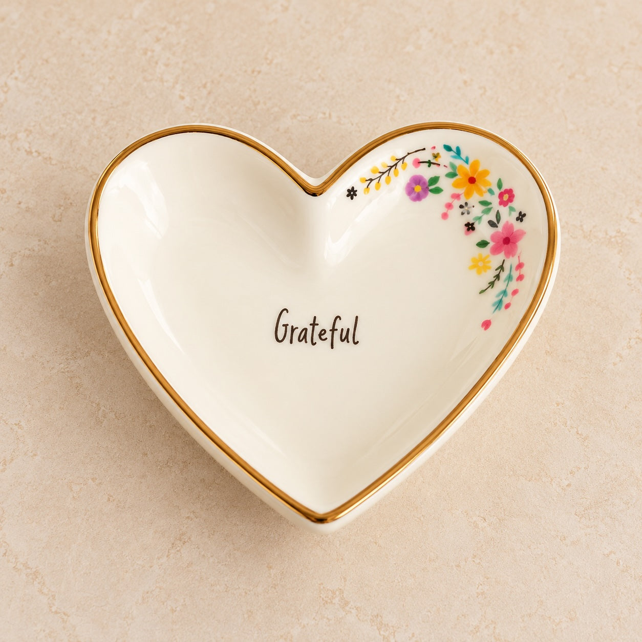 Medium cream ceramic heart trinket dish with gold-toned rim, colourful flowers and Grateful lettering.
