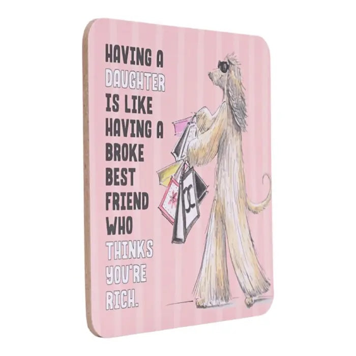 Side view of Having a Daughter coffee coaster with pink background and hand-drawn dog carrying shopping bags.