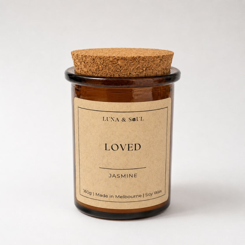Luna &amp; Soul I Am Loved affirmation soy candle in amber glass with natural cork lid.