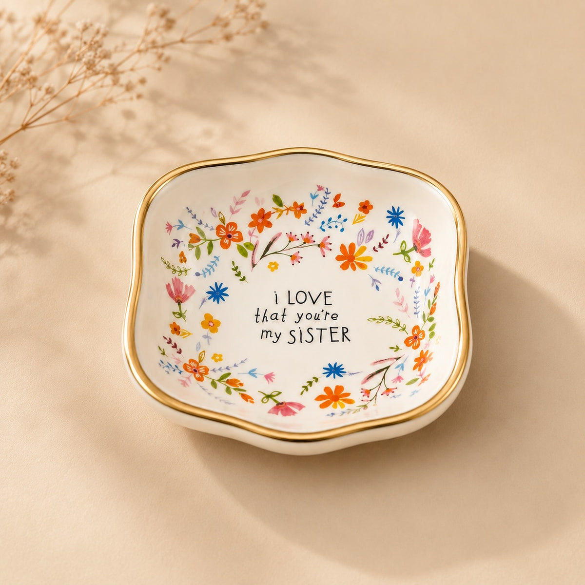 Luna &amp; Soul ceramic trinket dish with colourful floral artwork, gold edging and the message "I love that you're my sister."