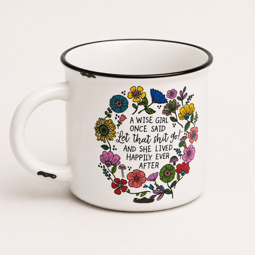 White enamel style mug with colourful floral wreath illustration and humorous “A wise girl once said let that shit go and she lived happily ever after” quote.