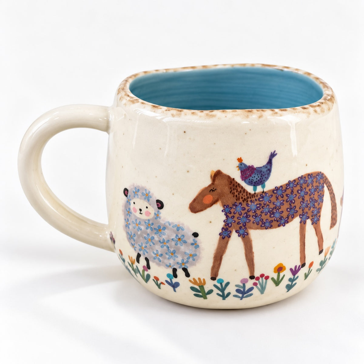 Back of ceramic animal mug with soft blue interior and hand-moulded shape.