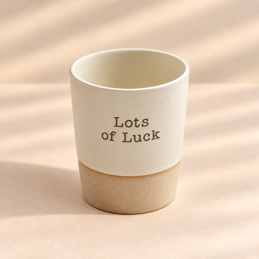 Lots of Luck hand-glazed ceramic mug in soft natural cream with earthy ceramic base.