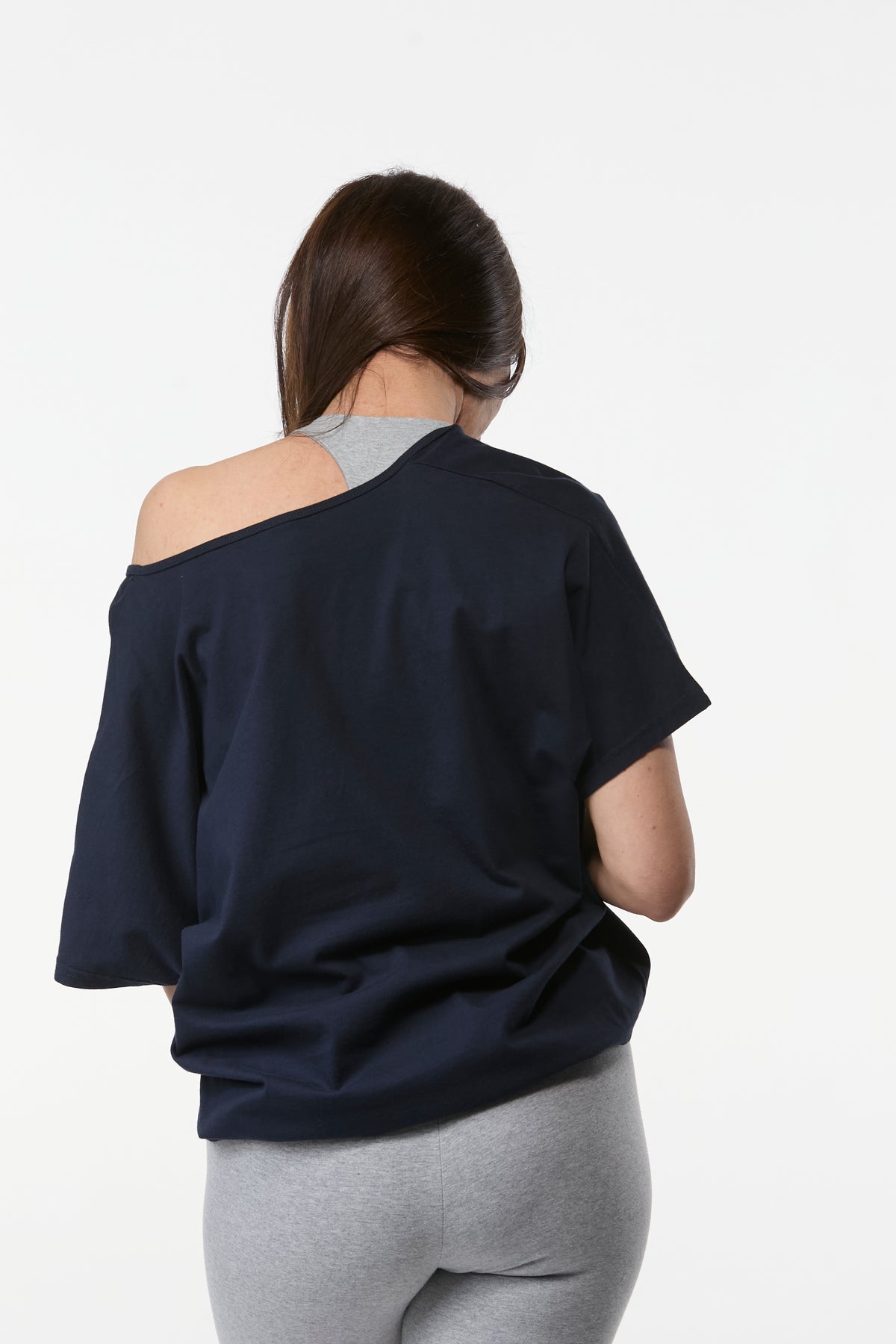 Back view of women’s navy organic cotton yoga tee with relaxed fit and soft draping shape
