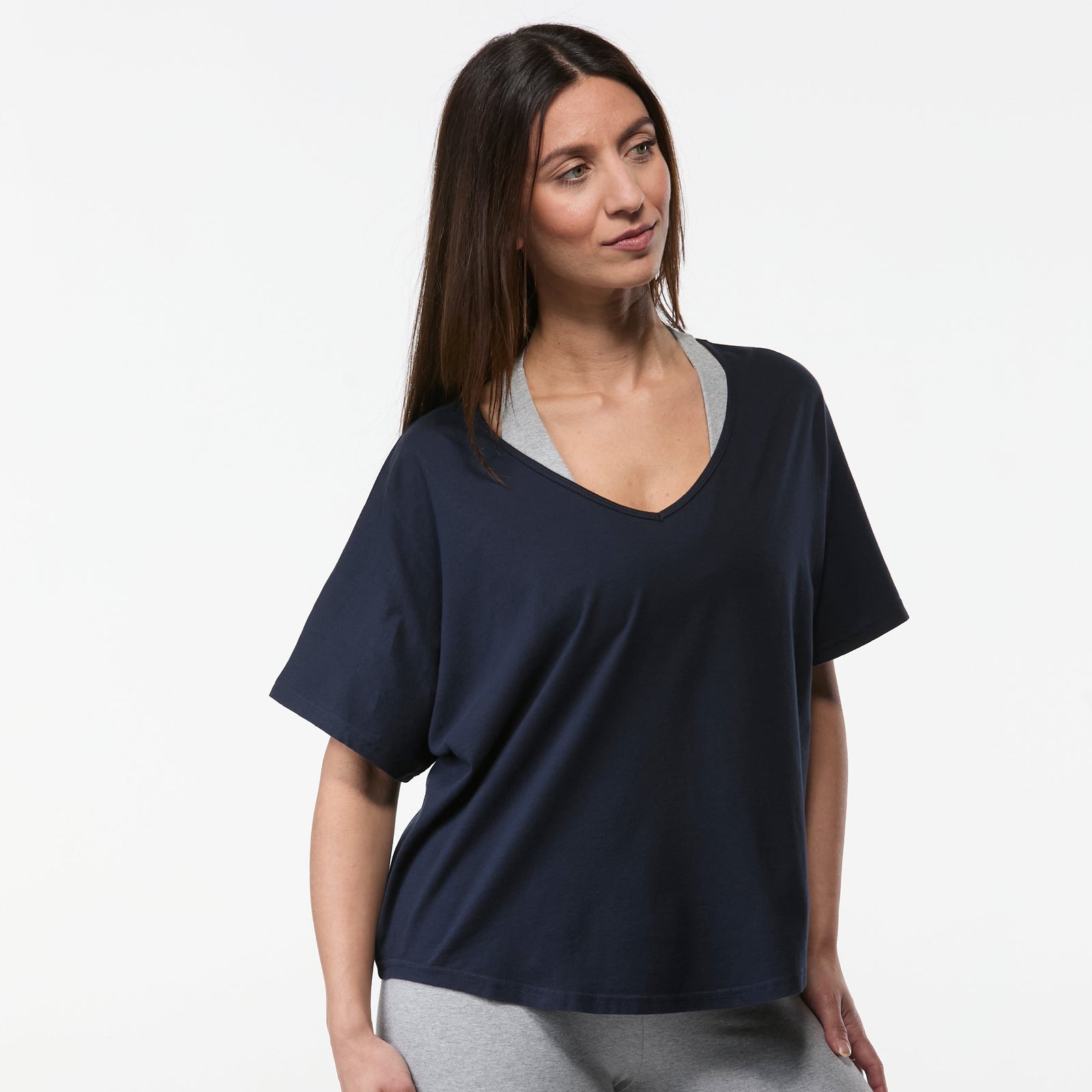 Woman modelling navy organic cotton yoga tee with relaxed silhouette and comfortable everyday fit
