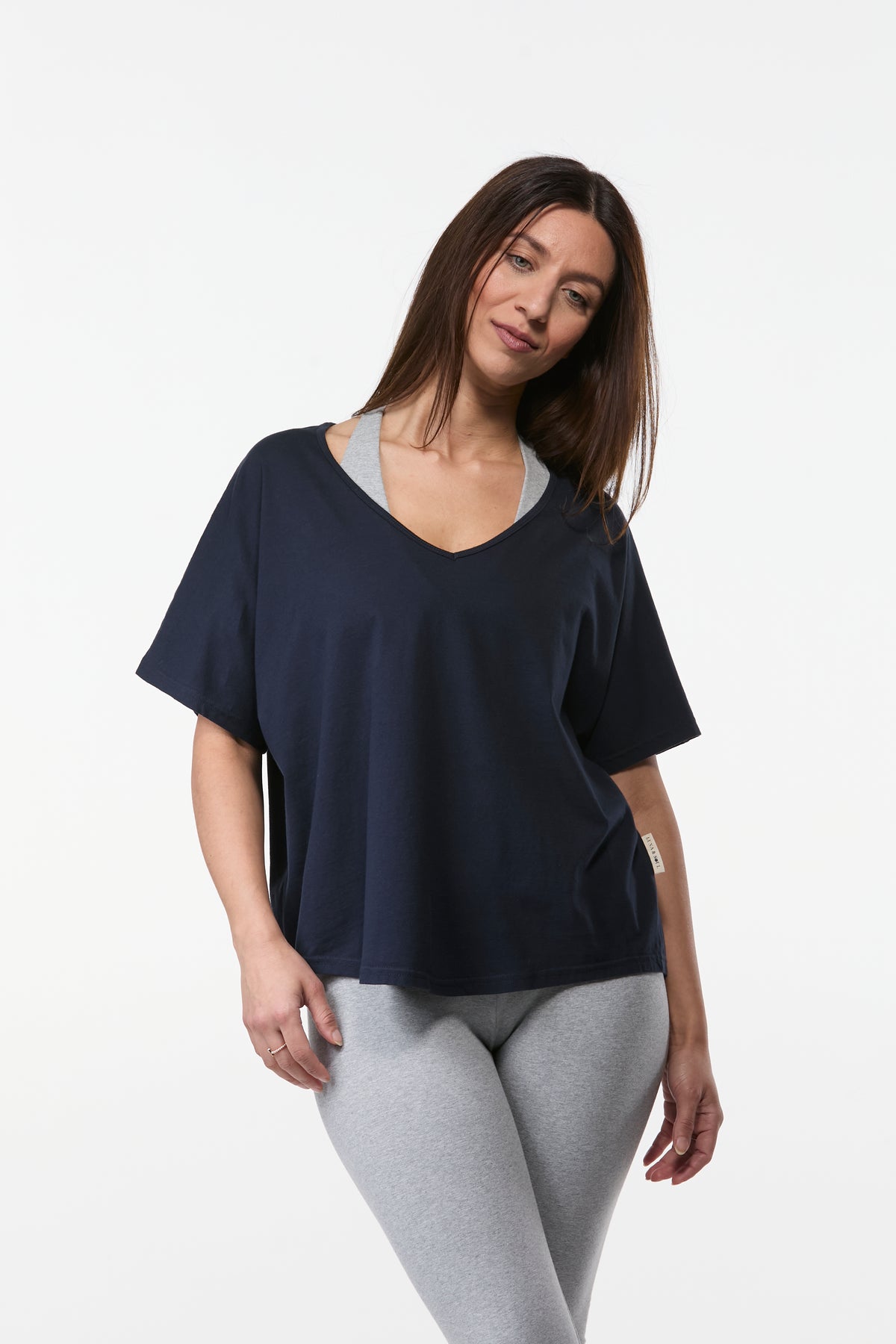 Front view of navy organic cotton yoga tee on woman with relaxed drape and soft comfortable fit
