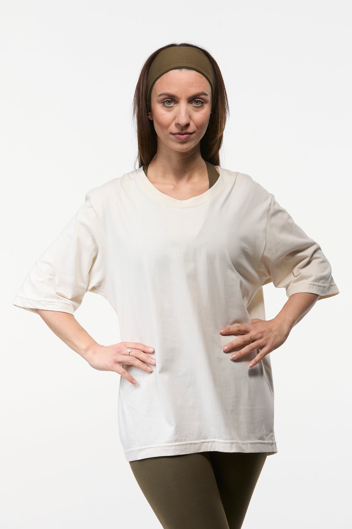 Woman wearing a oat oversized tee with khaki  leggings, relaxed fit top for yoga and everyday wear