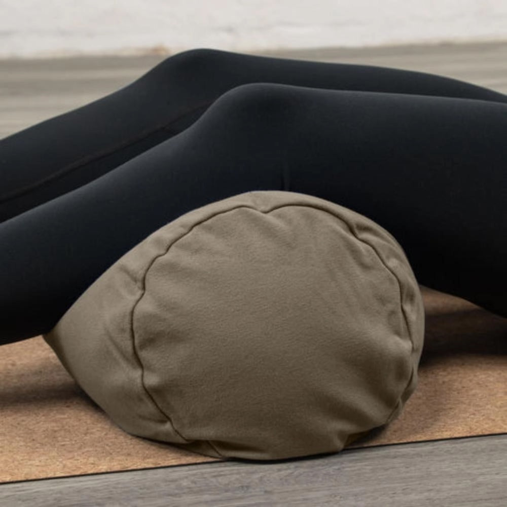 Luna &amp; Soul organic cotton yoga bolster in brown with cylindrical design for restorative yoga and meditation.