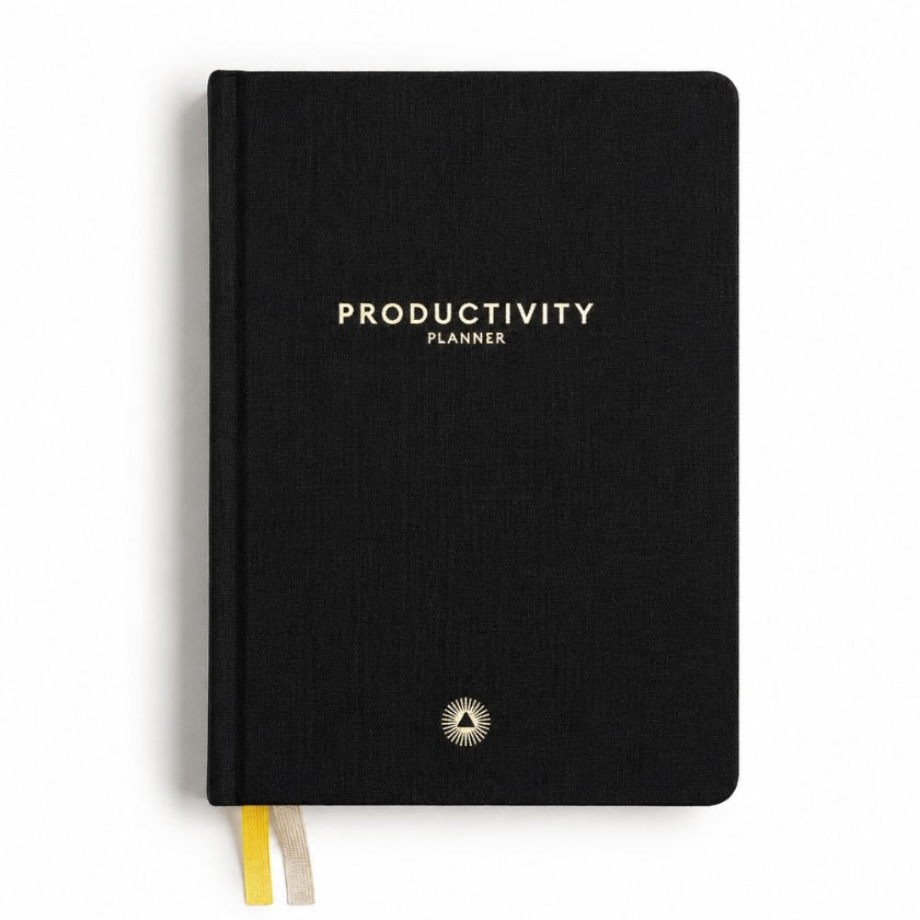 Black linen hardcover productivity planner with minimalist gold lettering, ribbon bookmarks and elegant modern design.