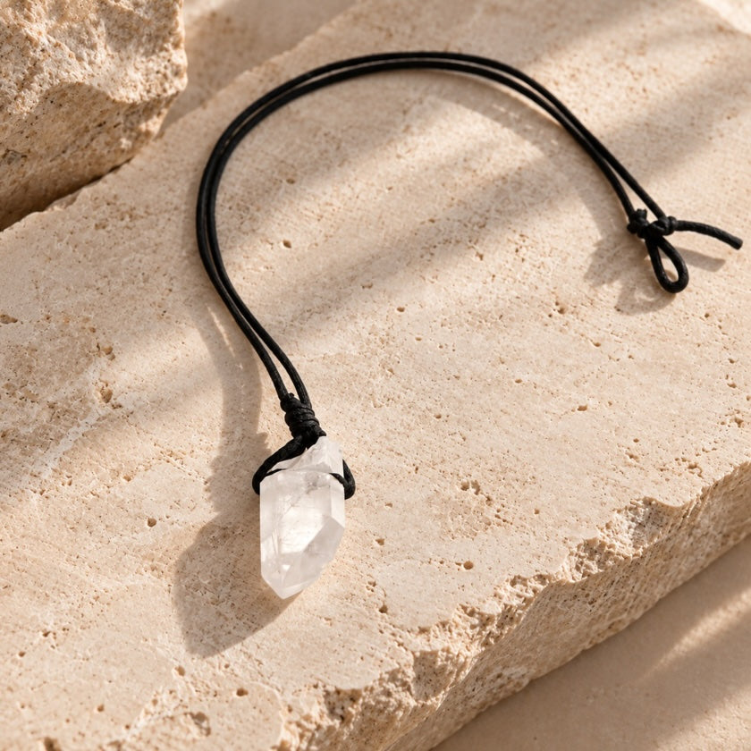 Raw clear quartz crystal necklace with natural crystal pendant on black cord.