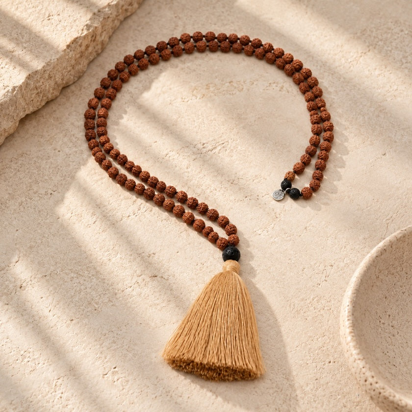 Rudraksha 108 bead mala necklace with natural golden tassel and sterling silver AUM disc.